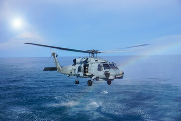 Military navy helicopter flying above the ocean.Copy space and background.