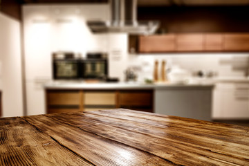 Wooden table background of free space for your decoration and blurred background of kitchen. Copy...