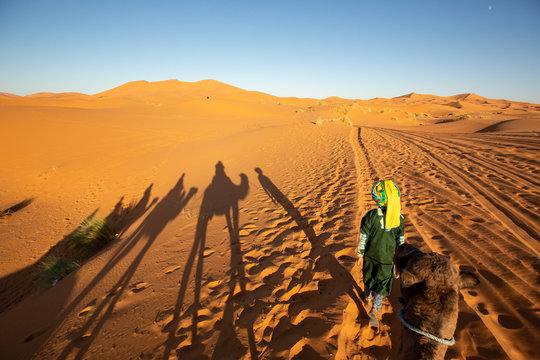 Berber man in Sahara Desert during sunset, Merzouga, Morocco