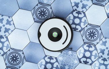 Top view on Vacuum Robot - cleaning hexagonal stylish floor in modern home