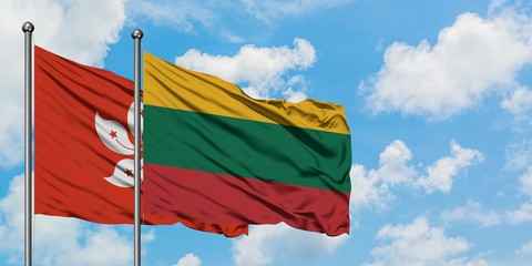 Hong Kong and Lithuania flag waving in the wind against white cloudy blue sky together. Diplomacy concept, international relations.