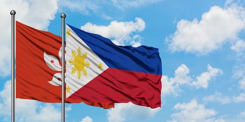 Hong Kong and Philippines flag waving in the wind against white cloudy blue sky together. Diplomacy concept, international relations.