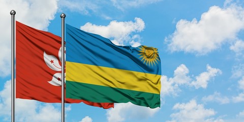 Hong Kong and Rwanda flag waving in the wind against white cloudy blue sky together. Diplomacy concept, international relations.