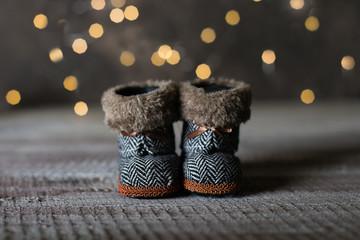 Holiday Christmas Baby Toy Small Boots on Wooden Table Background. Cozy Concept.