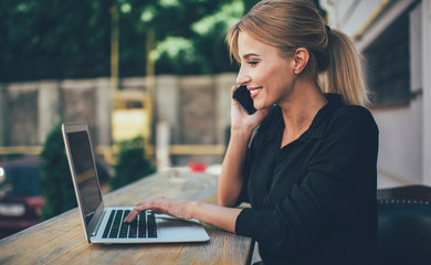 Successful female remote worker using roaming internet connection on cellphone for consultancy with...