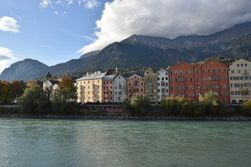 Fototapeta na wymiar Colourful houses in Innsbruck with river and mountains