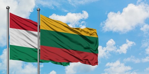 Hungary and Lithuania flag waving in the wind against white cloudy blue sky together. Diplomacy concept, international relations.