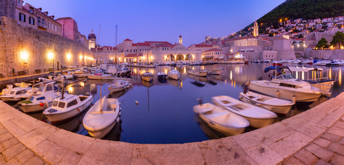 Naklejka na ściany i meble Panoramic view of The Old Harbour and Old Town of Dubrovnik durring morning blue hour, Croatia