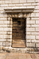 Venice, close-up of an ancient wooden door, bell tower of the Church of the Santi Apostoli (Holy Apostles), UNESCO world heritage site, Veneto, italy, Europe