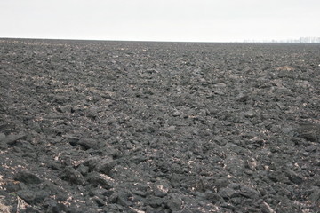 plowed field of black soil of Ukraine in autumn