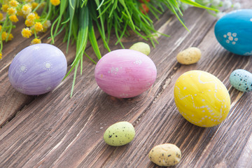 Obraz na płótnie Canvas Easter eggs painted in pastel colors on a wooden background