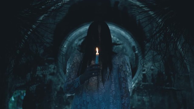 Witch holding candle in ancient crypt, working black magic, creating monster. Mutation horror scene