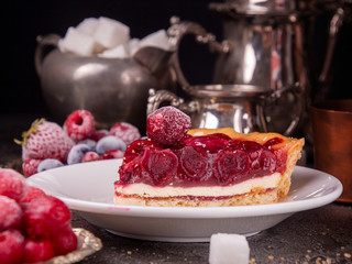 Cheesecake with cherry. Piece of cake on white plate.