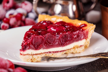 Cheesecake with cherry. Piece of cake on white plate.