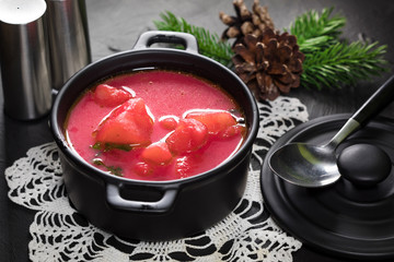 Red borscht soup in bowl.