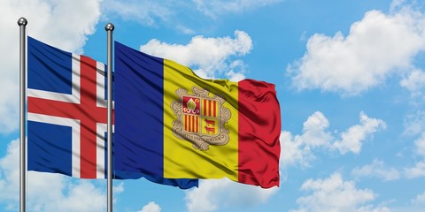 Iceland and Andorra flag waving in the wind against white cloudy blue sky together. Diplomacy...