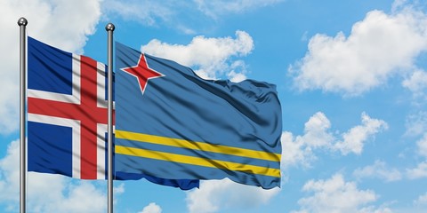 Iceland and Aruba flag waving in the wind against white cloudy blue sky together. Diplomacy concept, international relations.