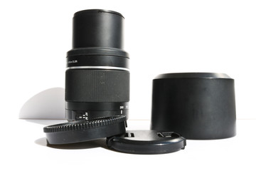 SLR telephoto lens and accessories - lens hood, cap on a white background.