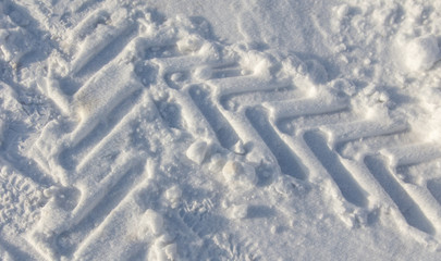 Traces of a car on white snow