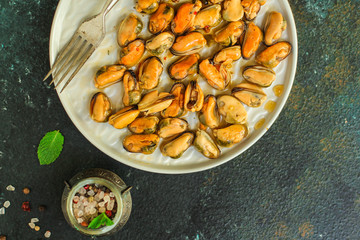 mussels in oil (delicious seafood) portion serving. top food background. copy space