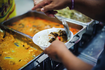 The poor who get hungry get free food donations from volunteers who come to serve : the concept of helping and hunger