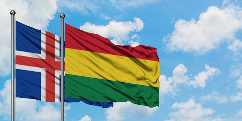 Iceland and Bolivia flag waving in the wind against white cloudy blue sky together. Diplomacy concept, international relations.