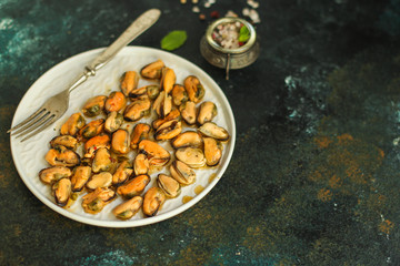 mussels in oil (delicious seafood) portion serving. top food background. copy space