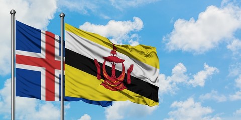 Iceland and Brunei flag waving in the wind against white cloudy blue sky together. Diplomacy...