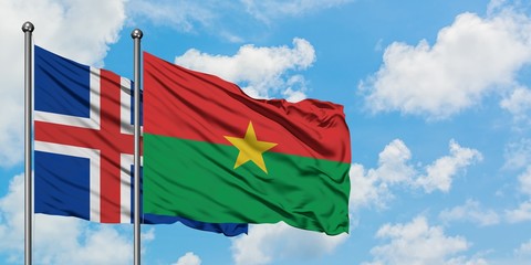 Iceland and Burkina Faso flag waving in the wind against white cloudy blue sky together. Diplomacy concept, international relations.