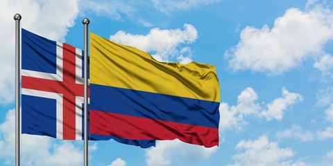 Iceland and Colombia flag waving in the wind against white cloudy blue sky together. Diplomacy concept, international relations.
