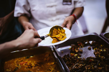 Refugees' hands are receiving food from philanthropists: the concept of hunger problems for the poor