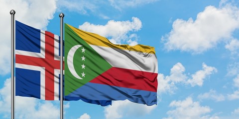 Iceland and Comoros flag waving in the wind against white cloudy blue sky together. Diplomacy concept, international relations.