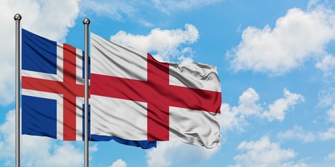 Iceland and England flag waving in the wind against white cloudy blue sky together. Diplomacy...