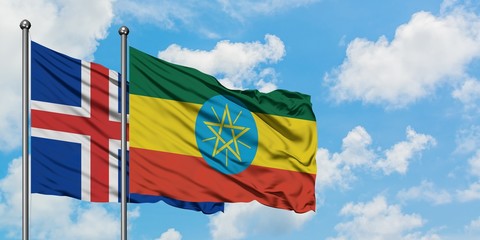 Iceland and Ethiopia flag waving in the wind against white cloudy blue sky together. Diplomacy...