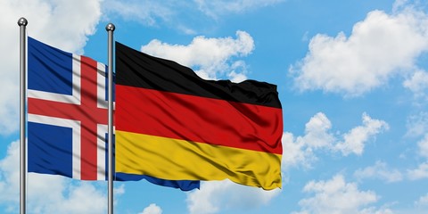 Iceland and Germany flag waving in the wind against white cloudy blue sky together. Diplomacy concept, international relations.