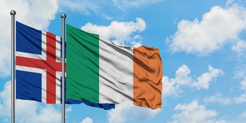 Iceland and Ireland flag waving in the wind against white cloudy blue sky together. Diplomacy...