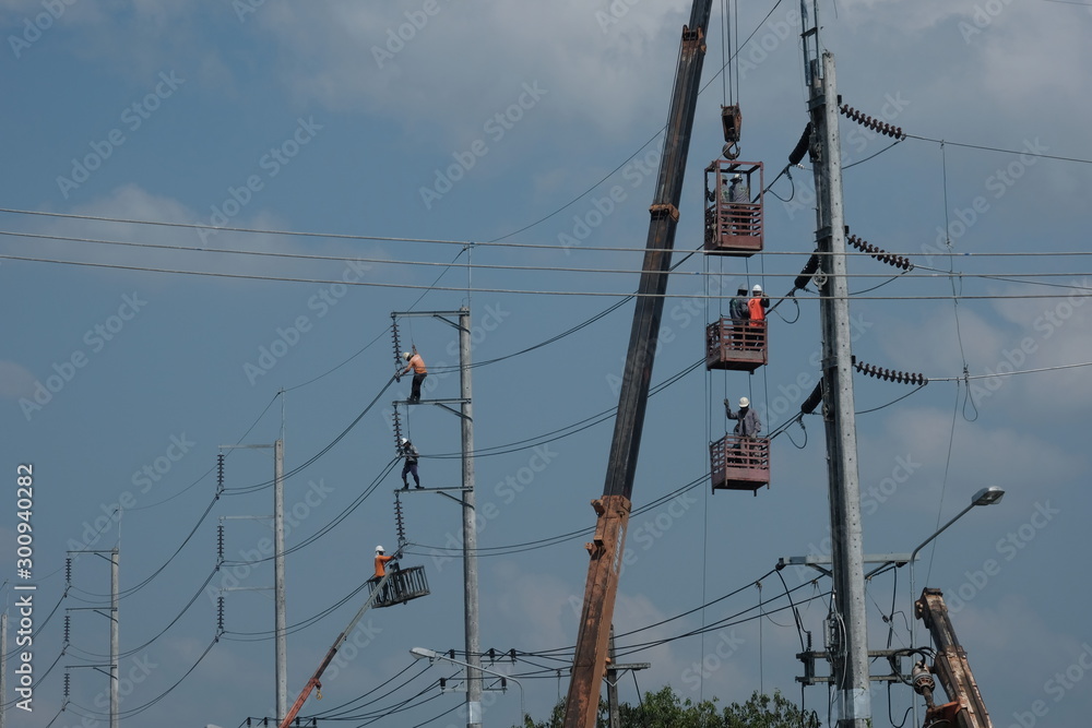 Wall mural 4 november 2019, mae sot, thailand electric officials are installing the high voltage electrical sys