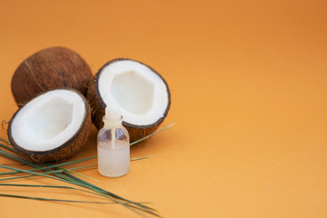 coconut oil on a poor background with coconut fruit for cosmetology and skin hydration
