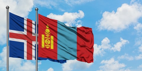 Iceland and Mongolia flag waving in the wind against white cloudy blue sky together. Diplomacy concept, international relations.