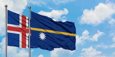 Iceland and Nauru flag waving in the wind against white cloudy blue sky together. Diplomacy...