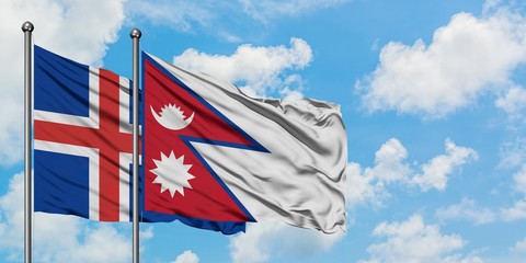 Iceland and Nepal flag waving in the wind against white cloudy blue sky together. Diplomacy concept, international relations.