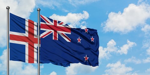 Iceland and New Zealand flag waving in the wind against white cloudy blue sky together. Diplomacy concept, international relations.