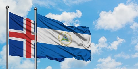 Iceland and Nicaragua flag waving in the wind against white cloudy blue sky together. Diplomacy concept, international relations.