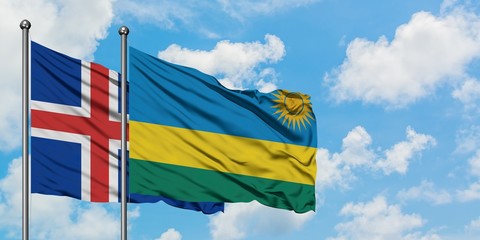Iceland and Rwanda flag waving in the wind against white cloudy blue sky together. Diplomacy concept, international relations.