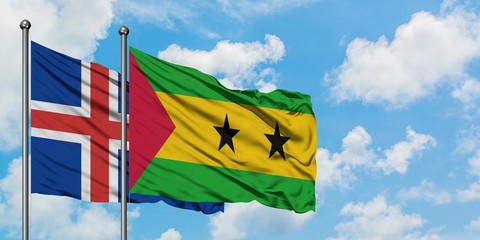 Iceland and Sao Tome And Principe flag waving in the wind against white cloudy blue sky together. Diplomacy concept, international relations.