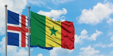 Iceland and Senegal flag waving in the wind against white cloudy blue sky together. Diplomacy concept, international relations.