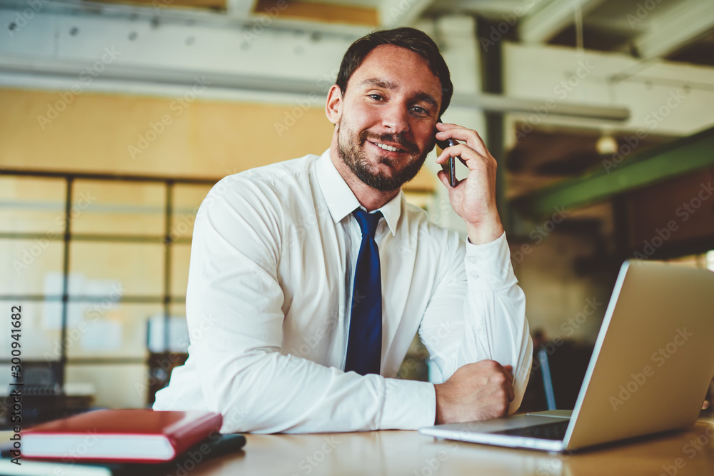 Aufkleber portrait of successful businessman looking at camera and enjoying friendly telephone conversation du