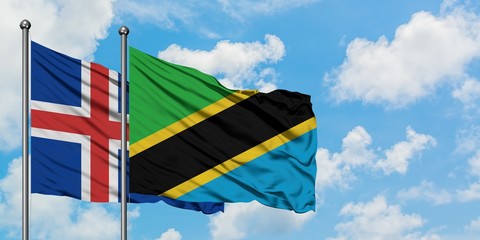 Iceland and Tanzania flag waving in the wind against white cloudy blue sky together. Diplomacy concept, international relations.