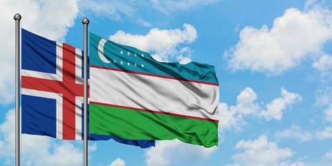 Iceland and Uzbekistan flag waving in the wind against white cloudy blue sky together. Diplomacy concept, international relations.