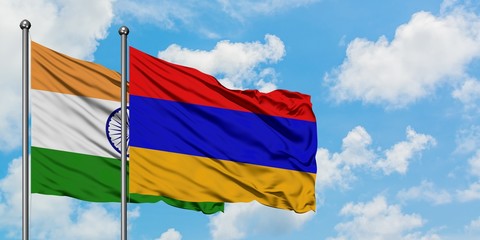 India and Armenia flag waving in the wind against white cloudy blue sky together. Diplomacy concept, international relations.